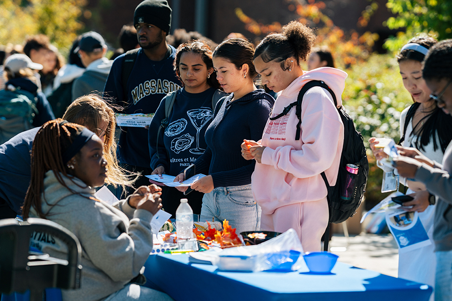 Students visit tables at the Wellness Walk