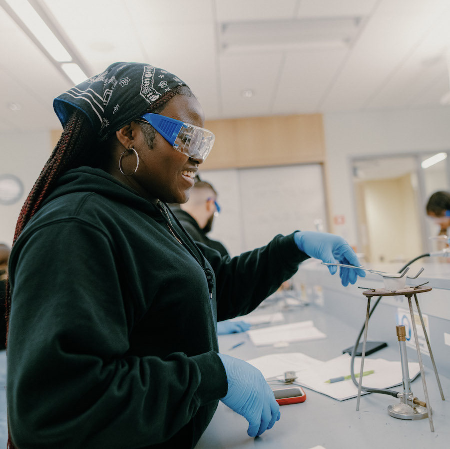 Student using the bunsen burner is science lab