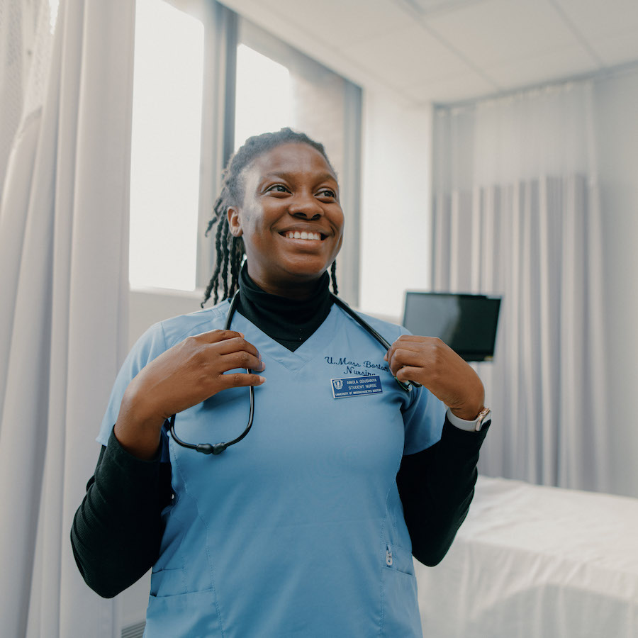 Nursing student smiling in lab