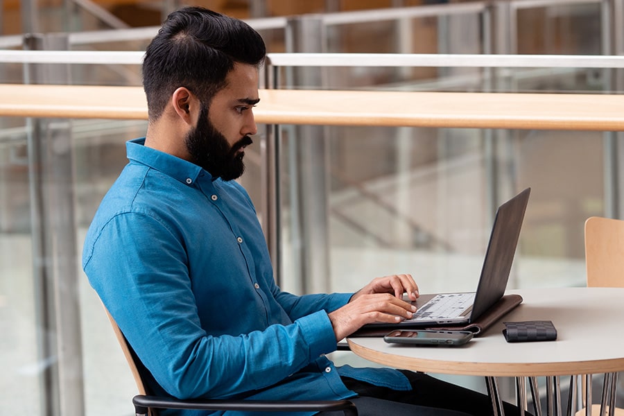 Male student types on his laptop