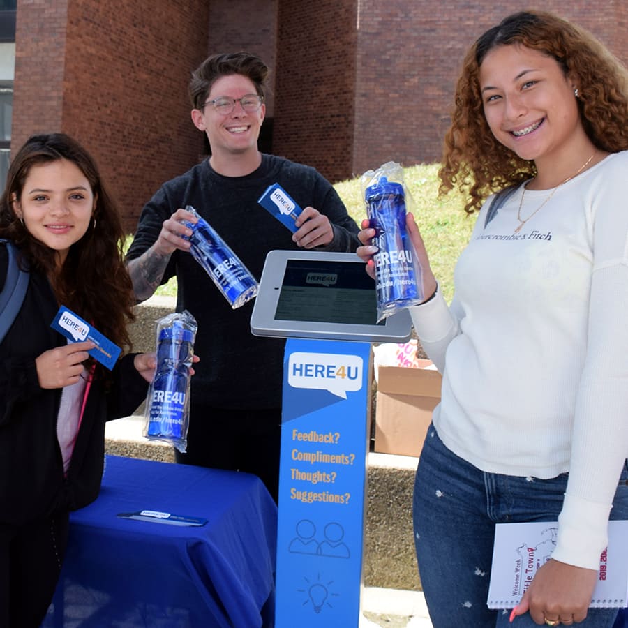 Students pose with here4u swag.