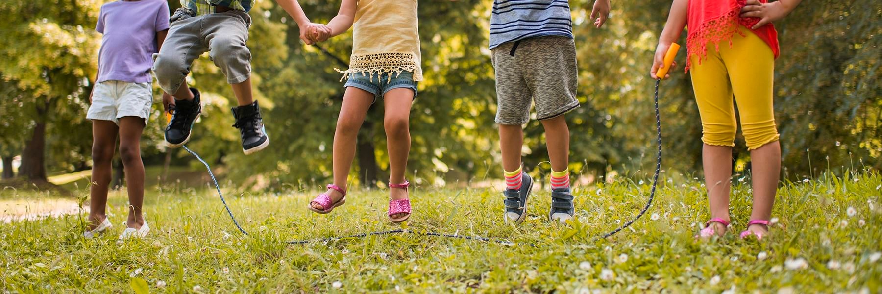 legs of children jumping in air