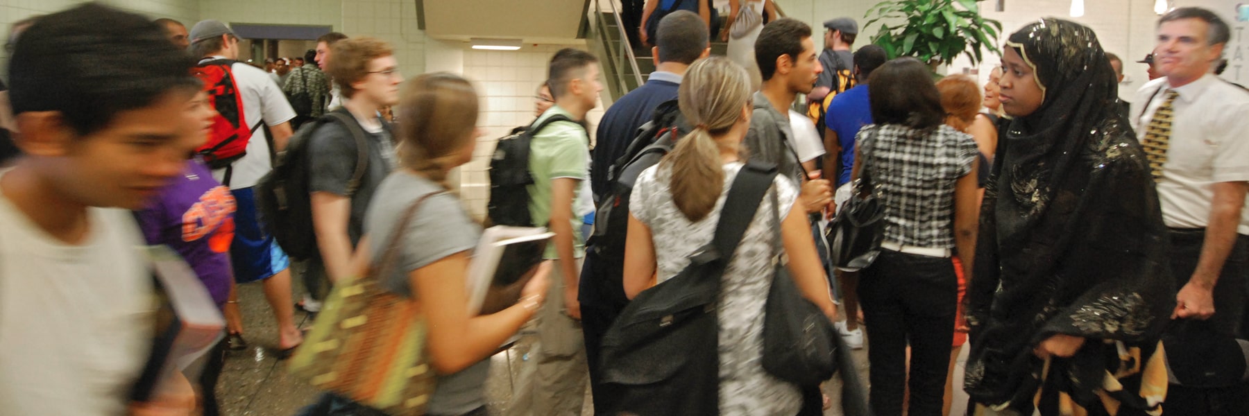 students in motion milling about in a crowd