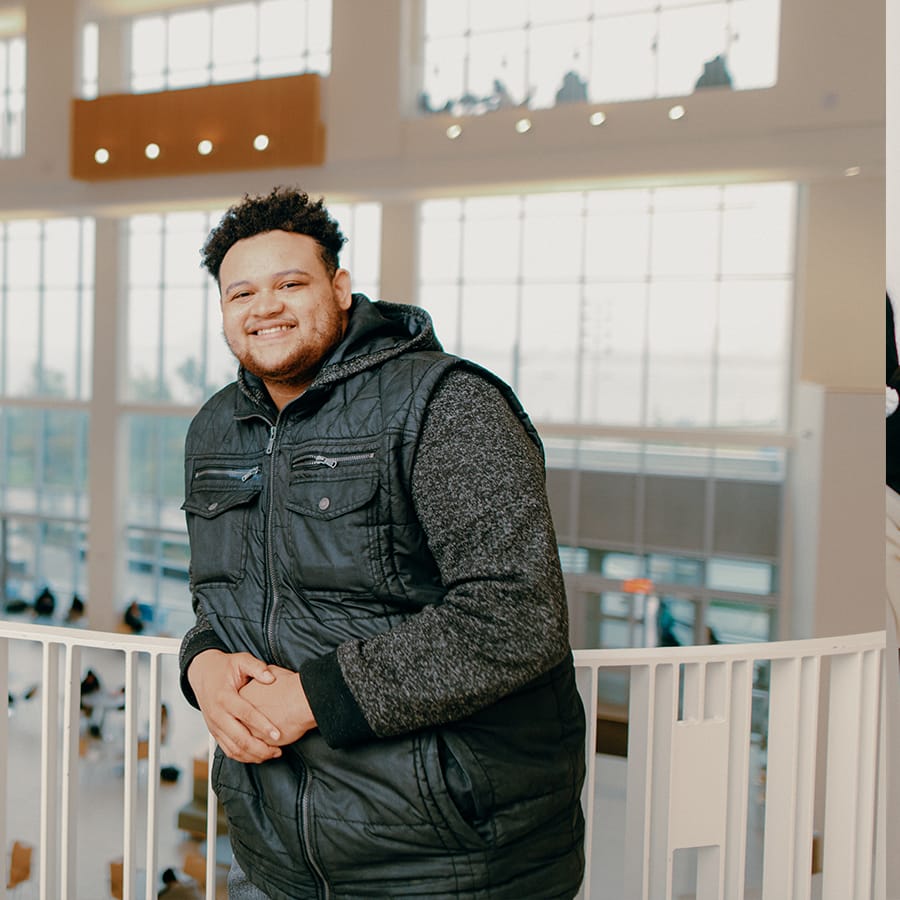 Student poses in front of ISC railing.