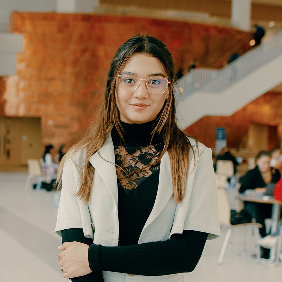 Valerie stands in lobby of Uhall.