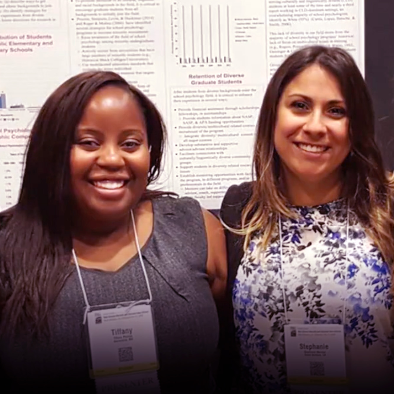 Two women students of Counseling and School Psychology smiling at a conference