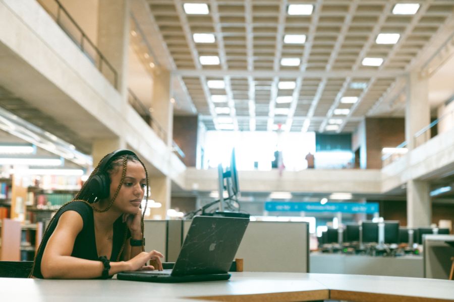 A student using a computer with headphones