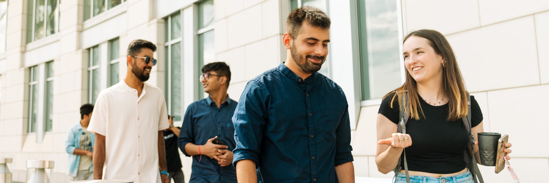 Graduate Students walking outside Campus Center